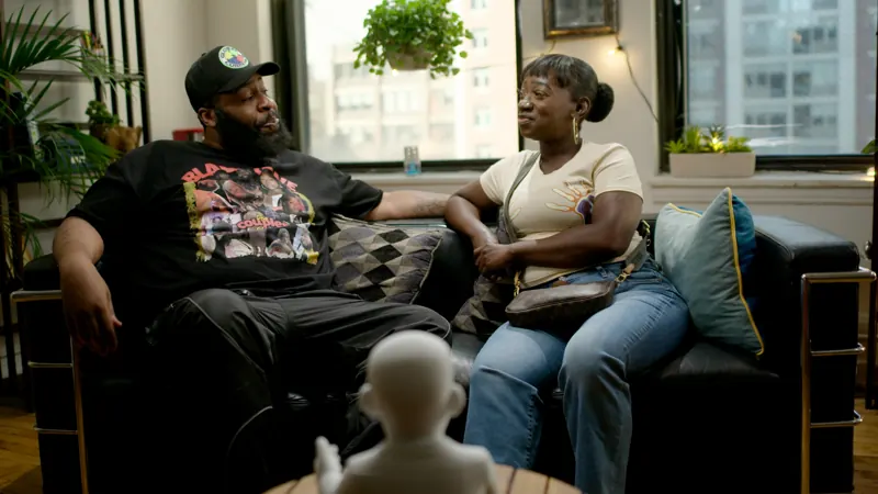 A married couple on the AL couch with AL in the foreground