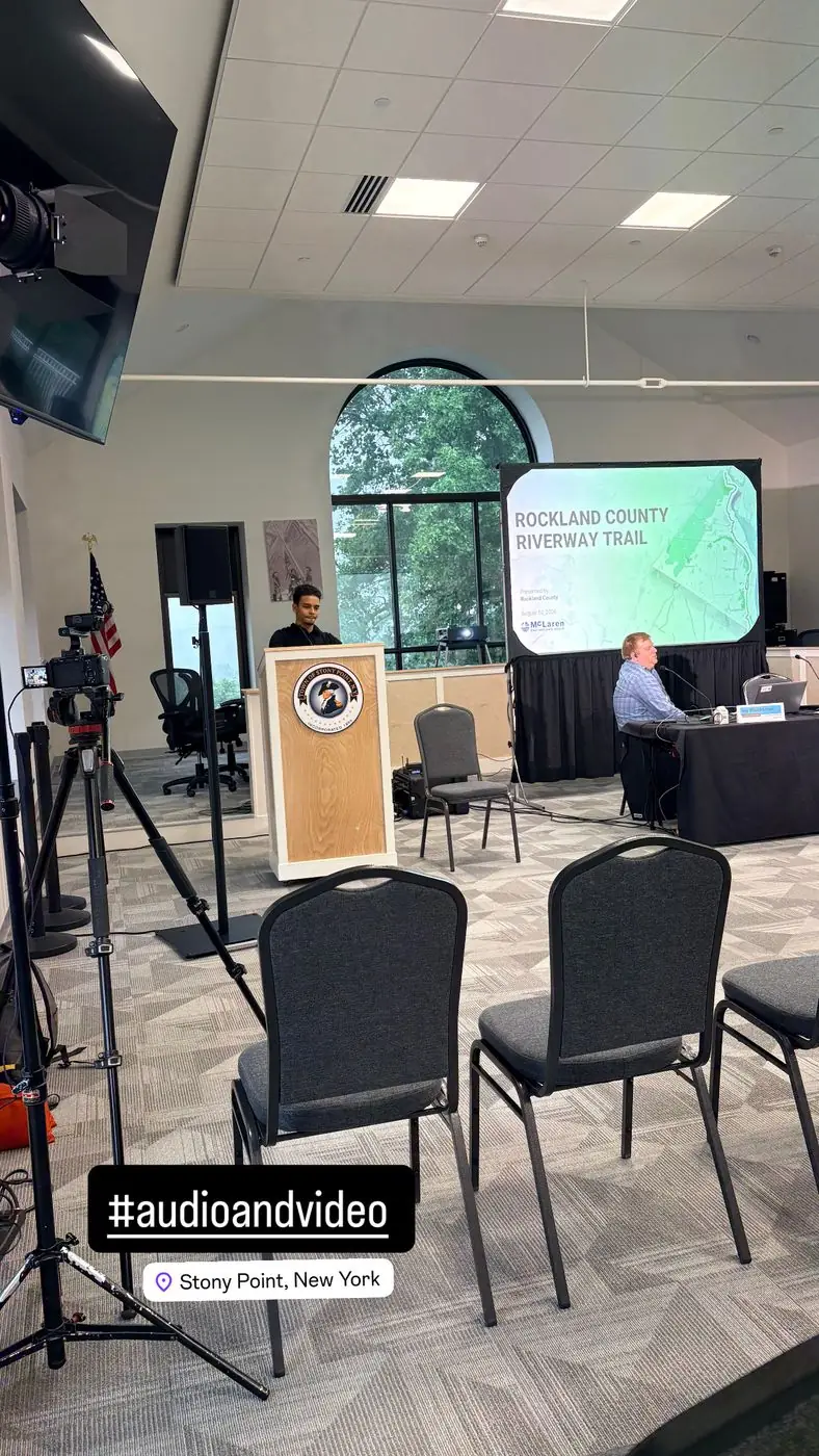 Podium presentation with large-format projected visuals produced by Transcendent Enterprise