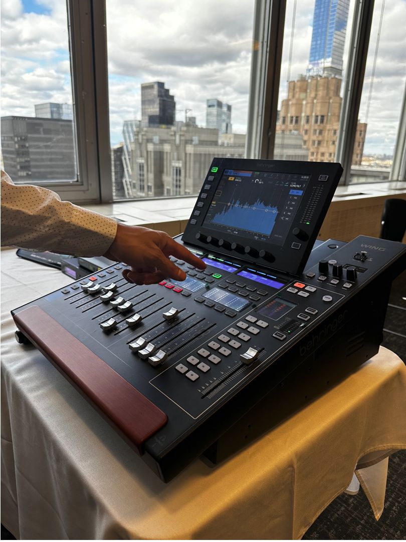 Behringer WING compact 48-channel mixer with Manhattan skyline — event audio mixing by Transcendent Enterprise