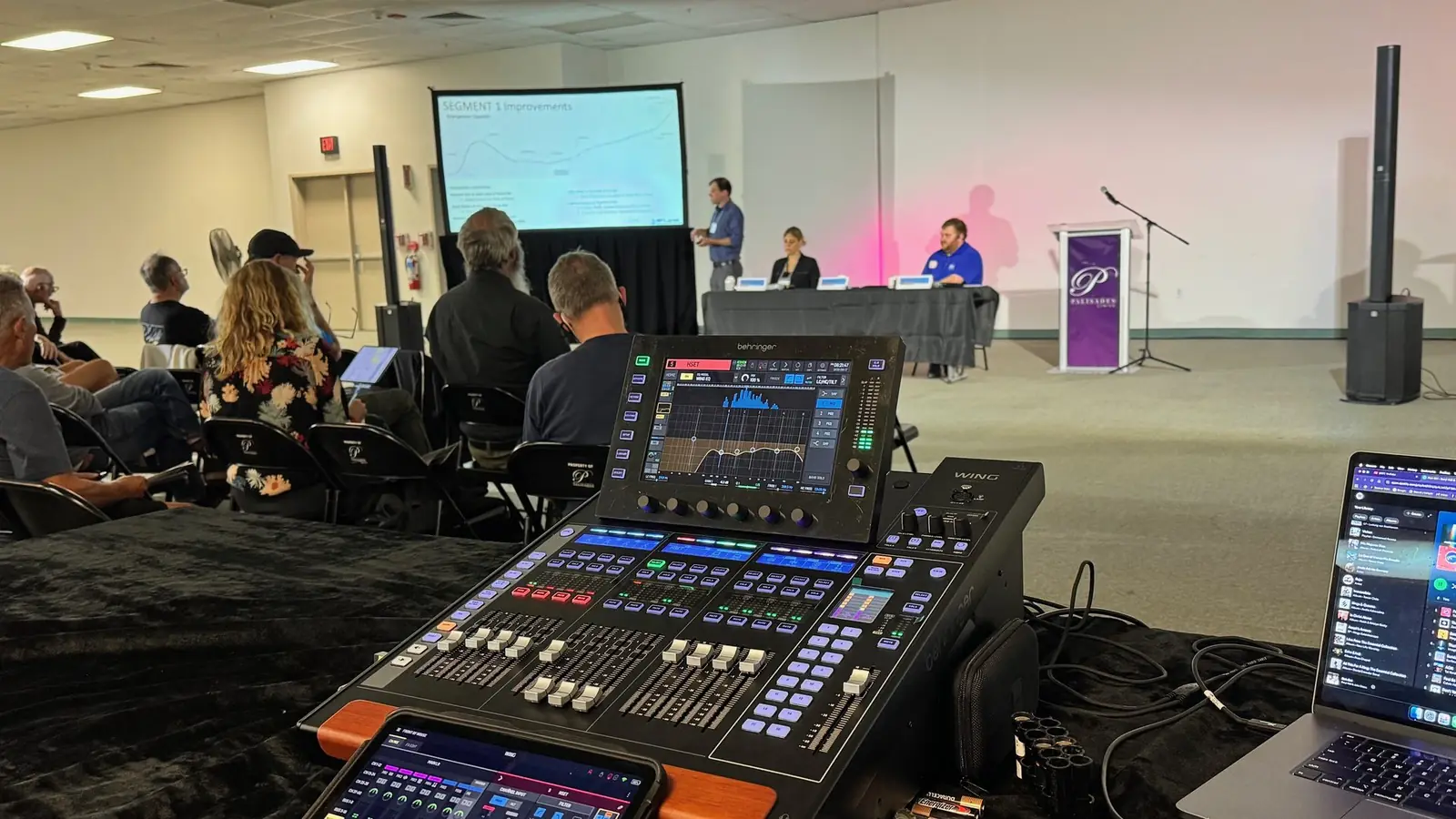 Event AV production — audio console, projection, and stage setup for a NYC corporate event