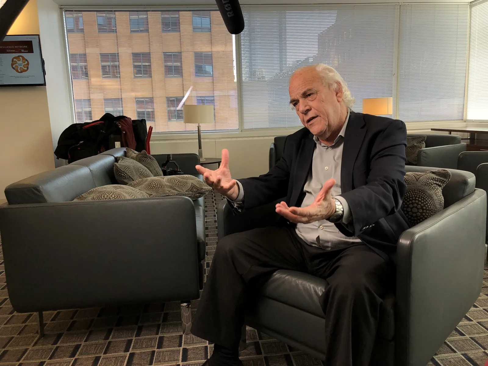 An executive being interviewed in a corner office with the Transcendent camera framed on him