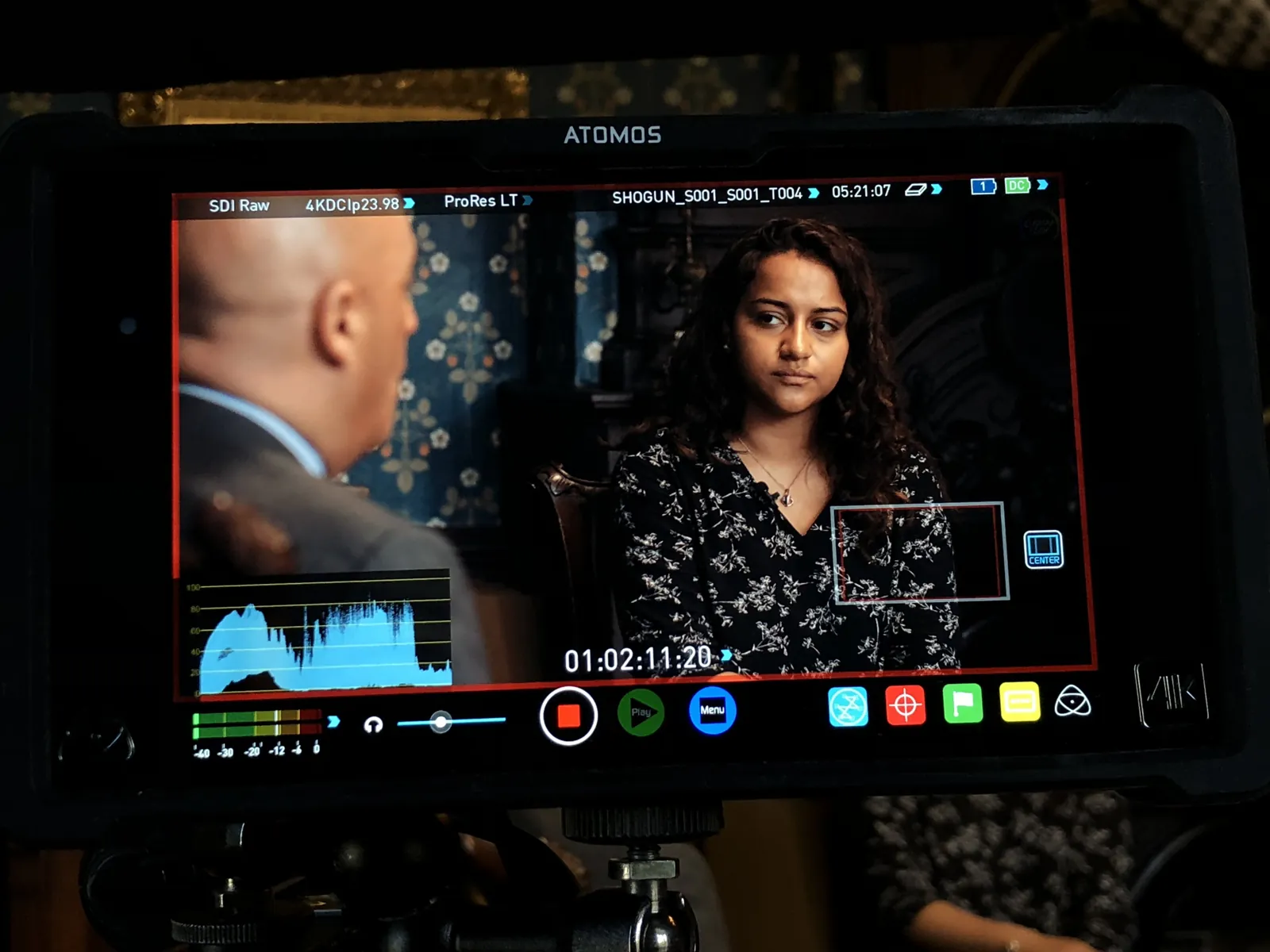 A production monitor showing the interview frame with scopes, so a remote producer can approve the shot