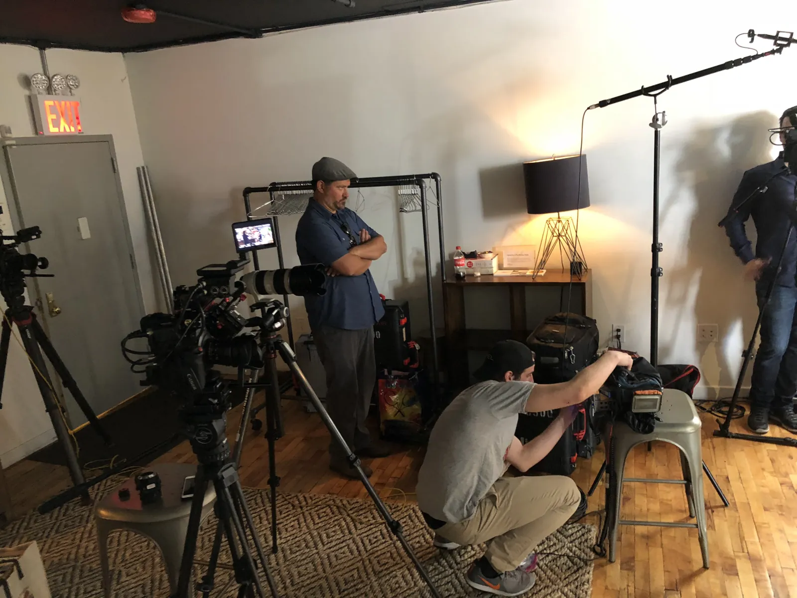 The Transcendent crew building a lit interview set inside a small New York studio
