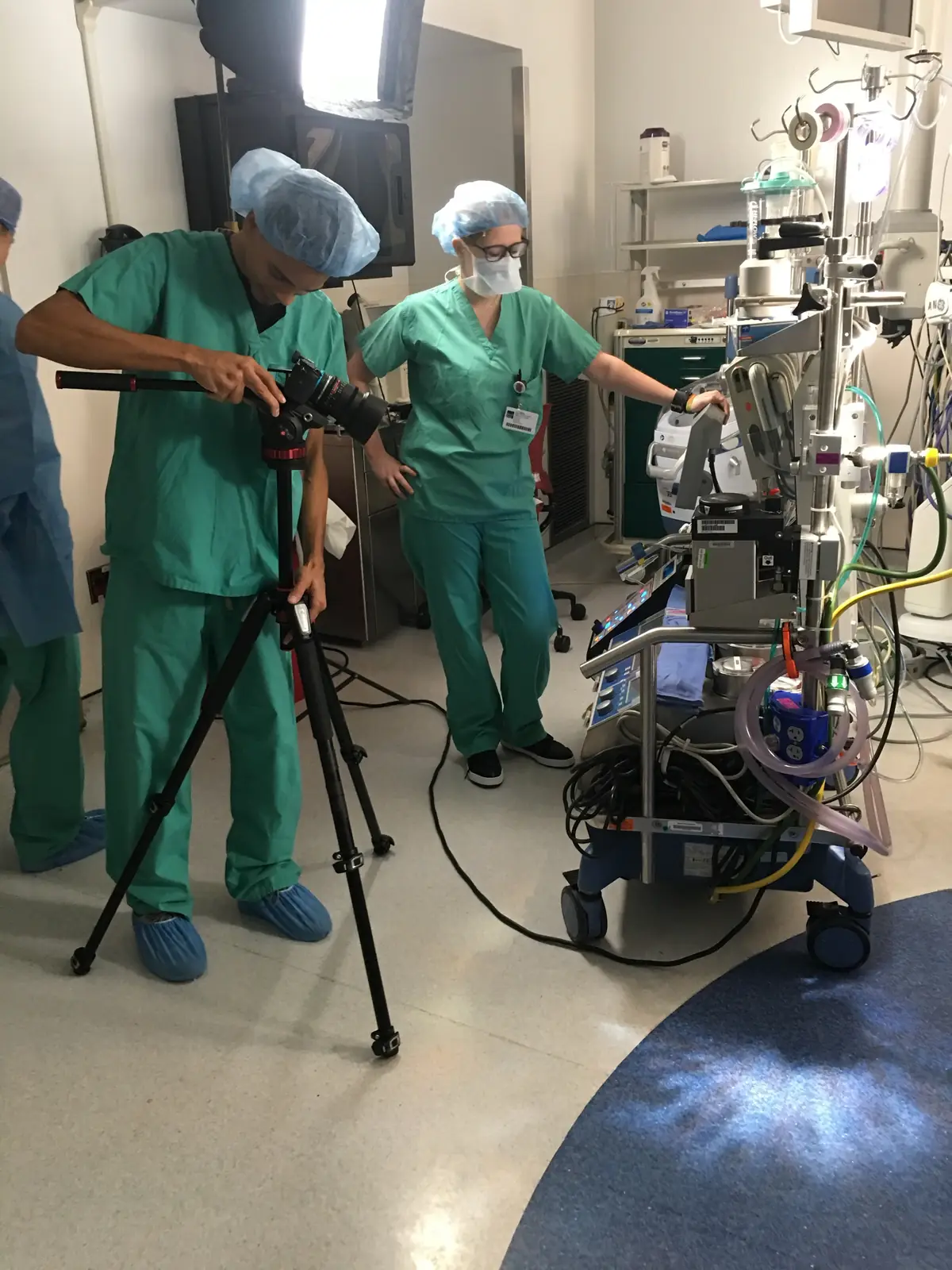 Crew in scrubs setting up a camera in a Mount Sinai operating room beside a clinician