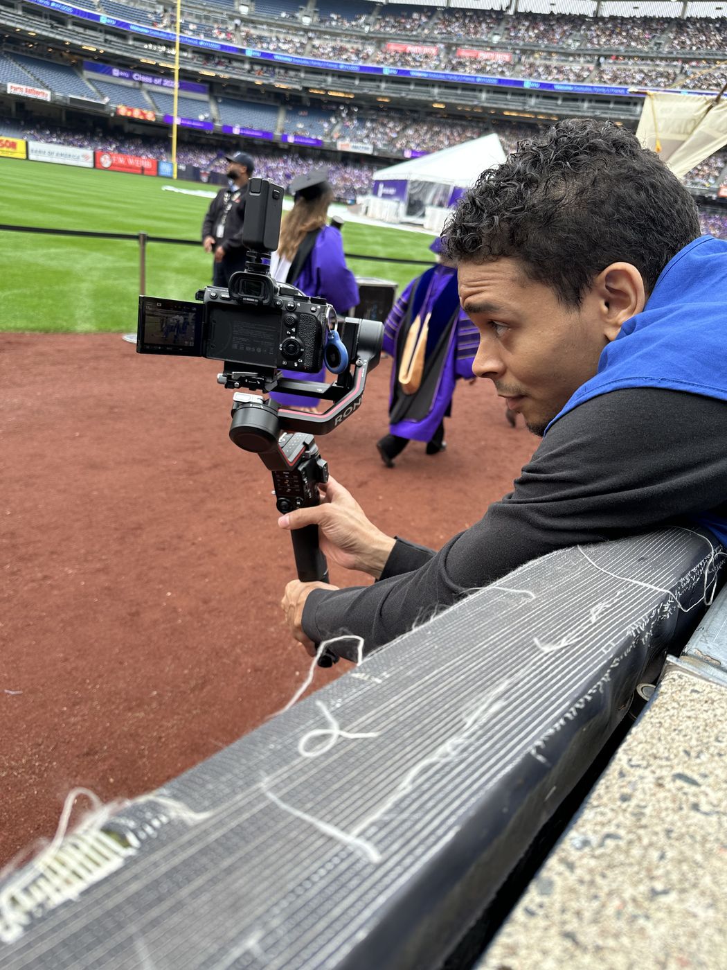 Transcendent Enterprise camera operator filming commencement programming at Yankee Stadium