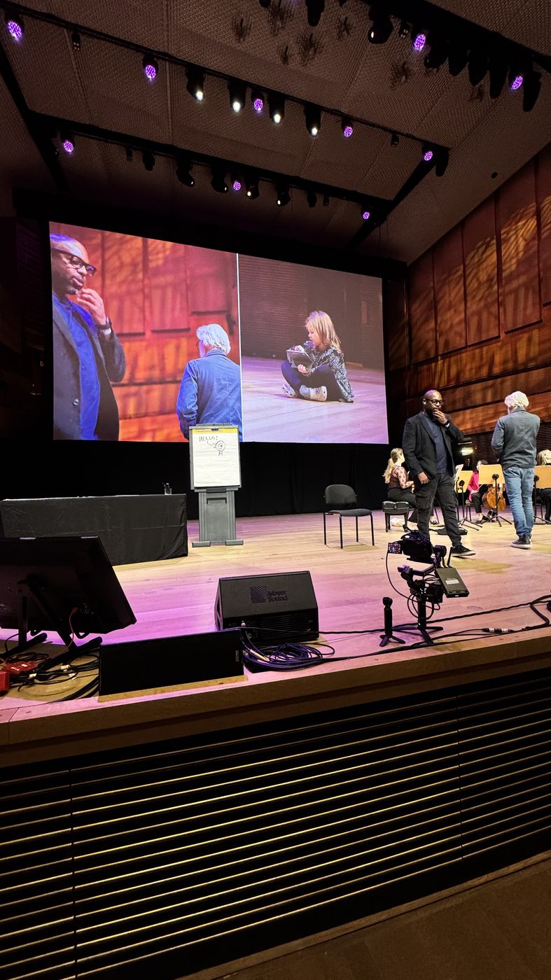 Concert hall stage with large screens during a live streamed event in NYC