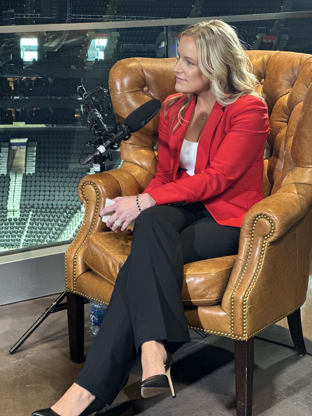 Host at the microphone during an arena podcast session produced by Transcendent Enterprise