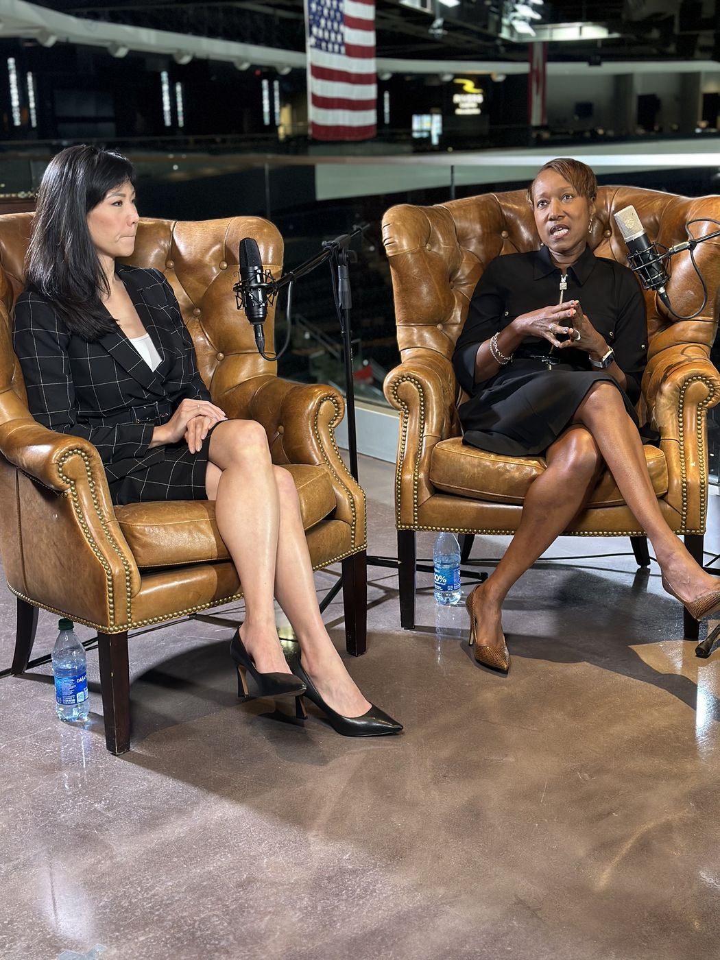 Two guests in conversation on an on-location podcast set