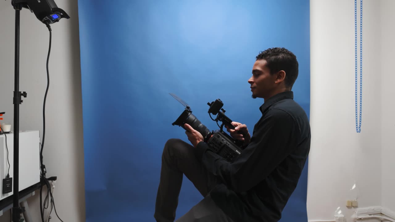 Talent on a blue backdrop during a studio shoot