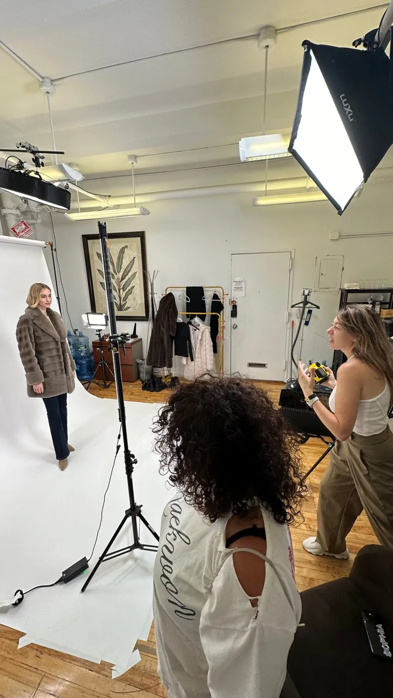 A photo shoot on a white seamless backdrop with a softbox light