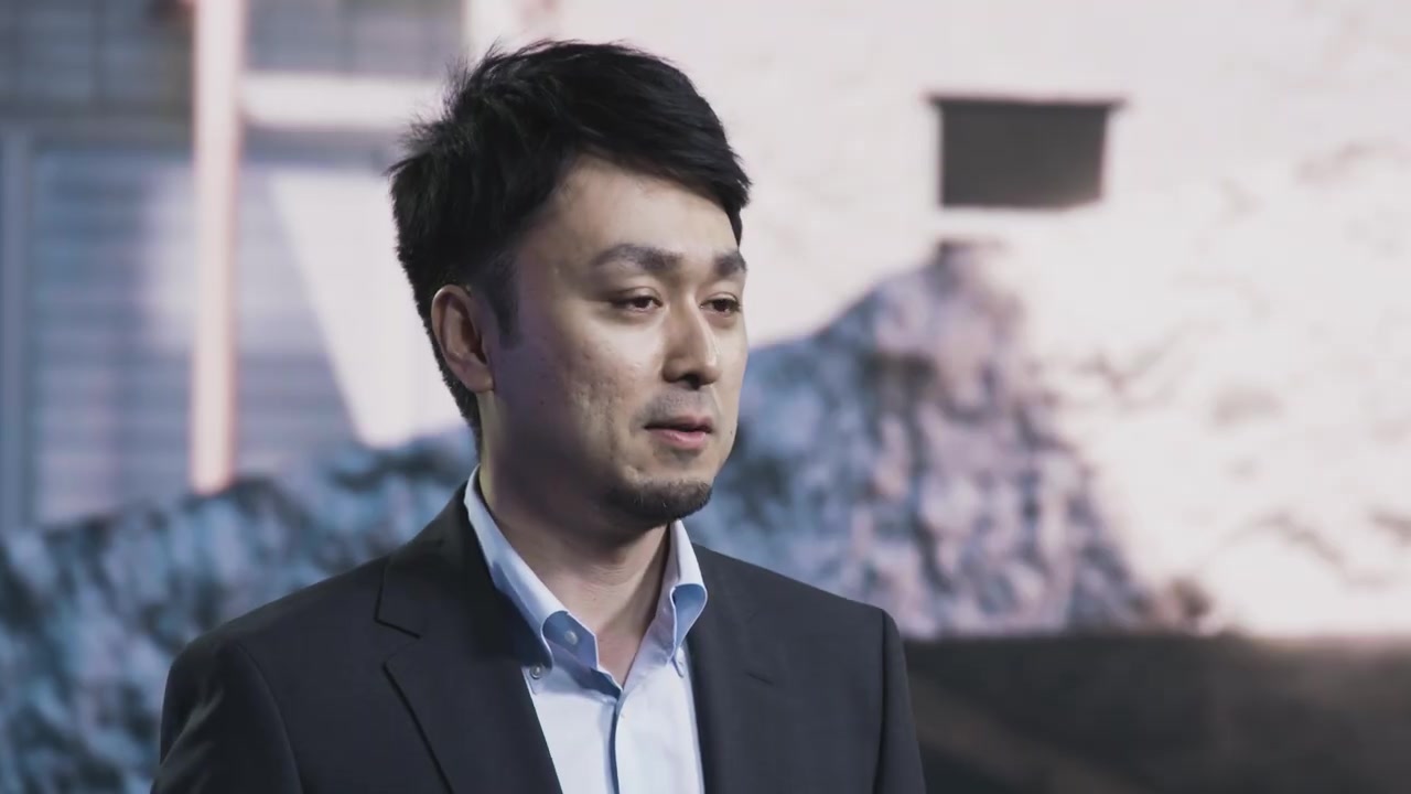 Presenter inside a cinematic rock-and-snow environment on the LED wall